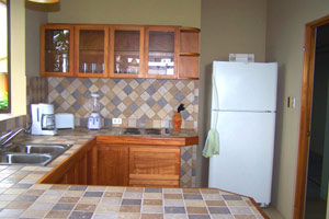 Very nice tile and woodwork make the kitchen a charming place.